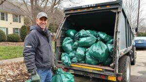 pair-garbage-men-hauling-trash-bags-back-waste-truck_693425-93617